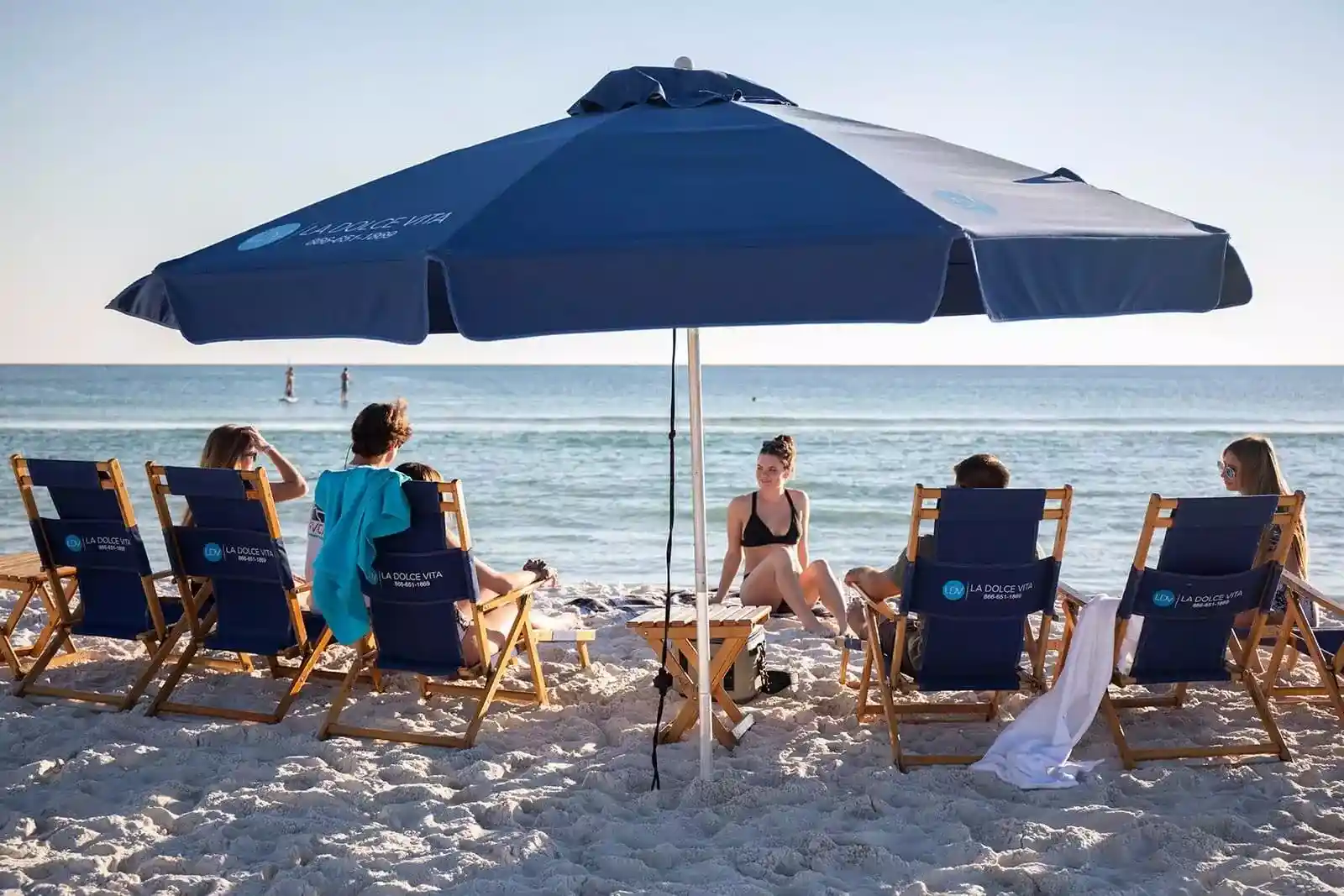 Beach setup with umbrella and chairs for group trip to Jersey Shore with Jitney Shuttle